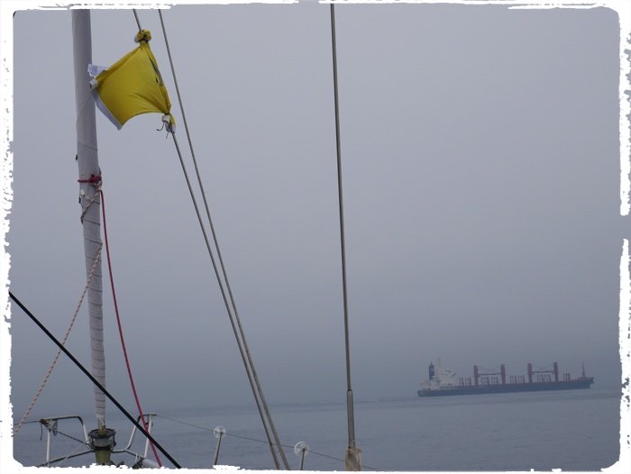 The only bright object in the fog was our improvised quarantine flag: Zan’s T-shirt. 