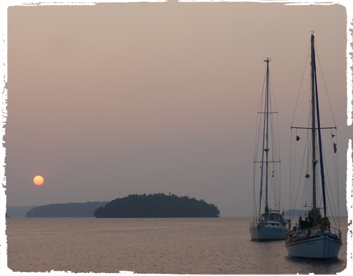 Calm anchorage in Tonga and the sunset affected by the ash from the Vanuatu volcano